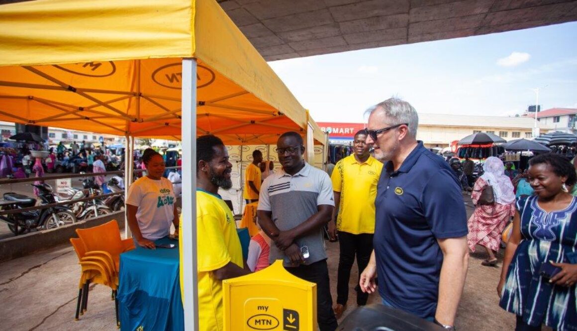 CEO Stephen Blewett Interacts with a Vendor in Tamale Market
